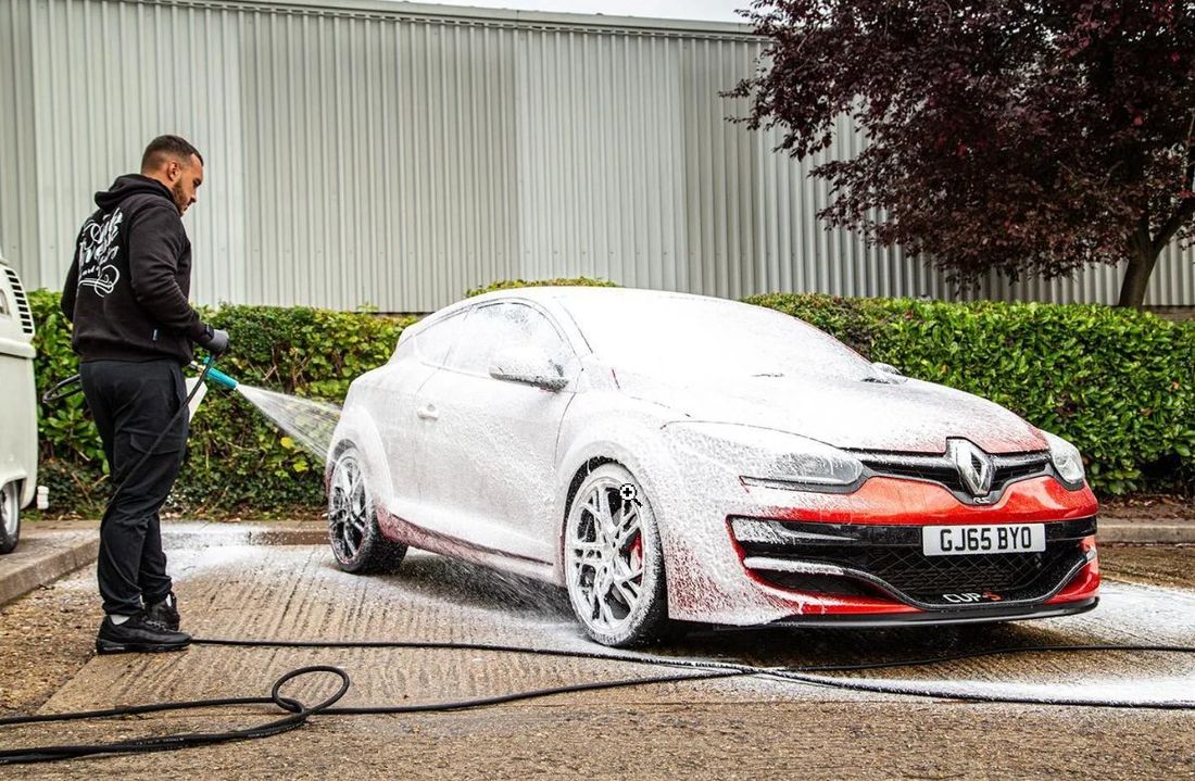AdsFlair mobile car valeting client washing a vehicle exterior with snow foam
